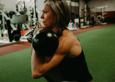 Photo of Kim Greenstein working out with kettle bells