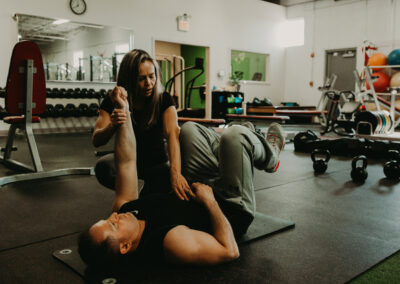 Photo of Kim Greenstein helping a client with core exercises