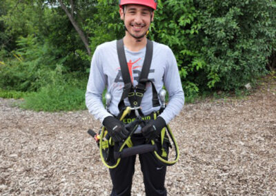 Photo of Jesus Gonzalez geared up for a ropes course.