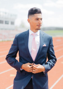 Photo of Jesus Gonzalez in a suit on a track